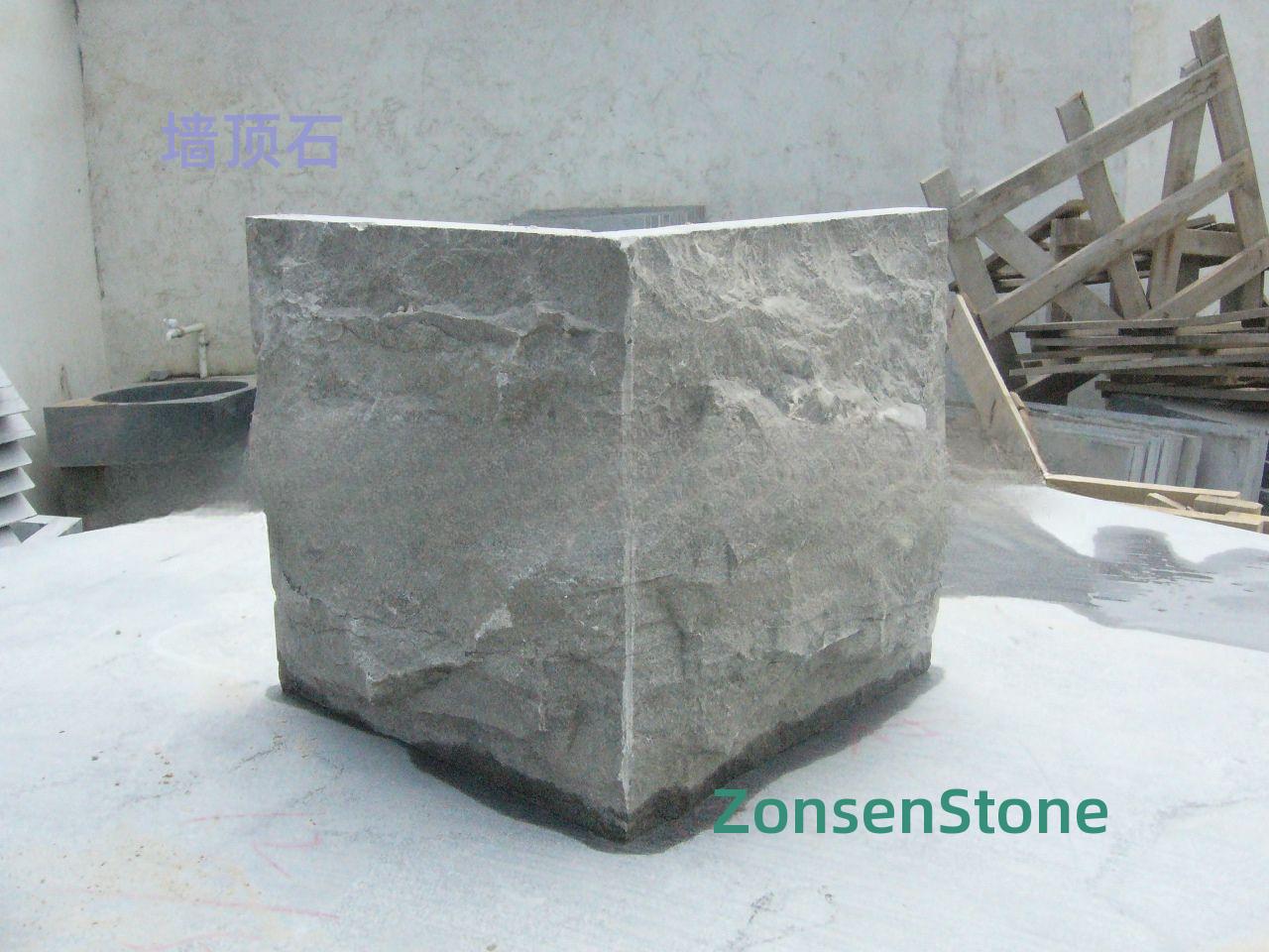 Stone at the top of the wall