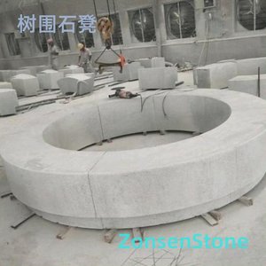 Tree surrounding stone bench